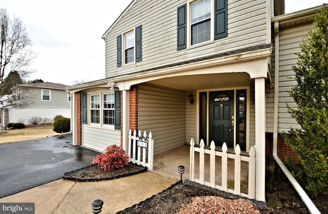 view of exterior entry featuring driveway