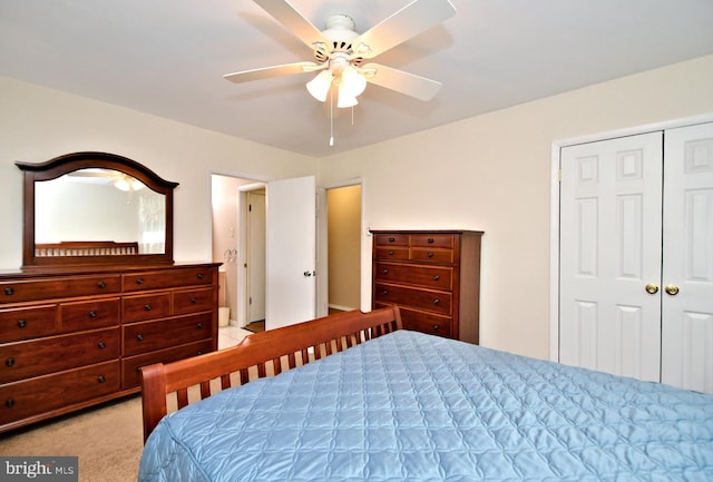 bedroom with a ceiling fan, a closet, and light carpet