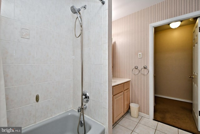 bathroom with bathtub / shower combination, tile patterned flooring, vanity, baseboards, and wallpapered walls