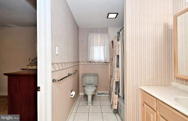 bathroom with wallpapered walls, toilet, a shower with curtain, tile patterned floors, and vanity