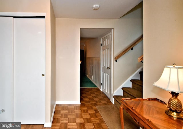 hall featuring stairs and baseboards