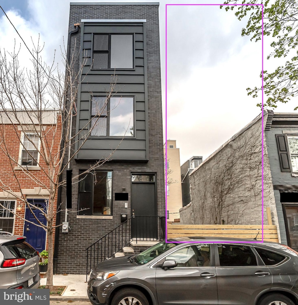 view of front of house featuring brick siding