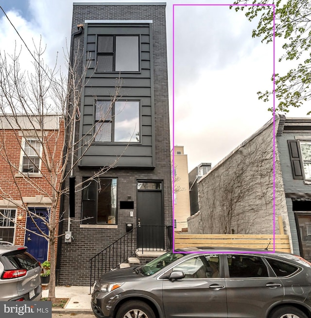 view of front of house featuring brick siding