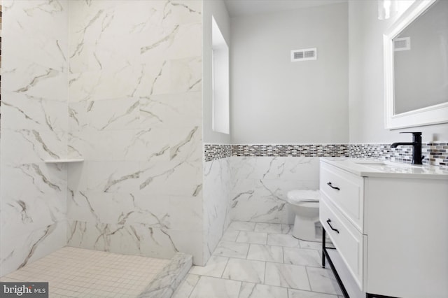 full bath featuring toilet, vanity, visible vents, marble finish floor, and walk in shower