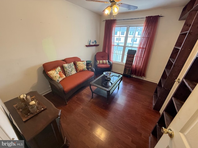 living room with wood finished floors, a ceiling fan, and baseboards