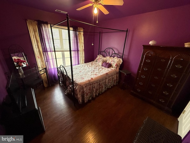 bedroom with visible vents, wood finished floors, and a ceiling fan