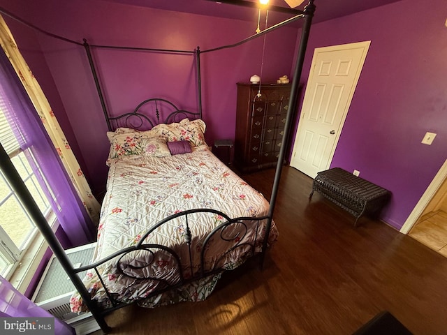 bedroom with baseboards and wood finished floors