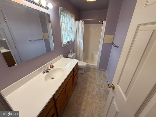 bathroom with tile patterned floors, a shower stall, toilet, and vanity