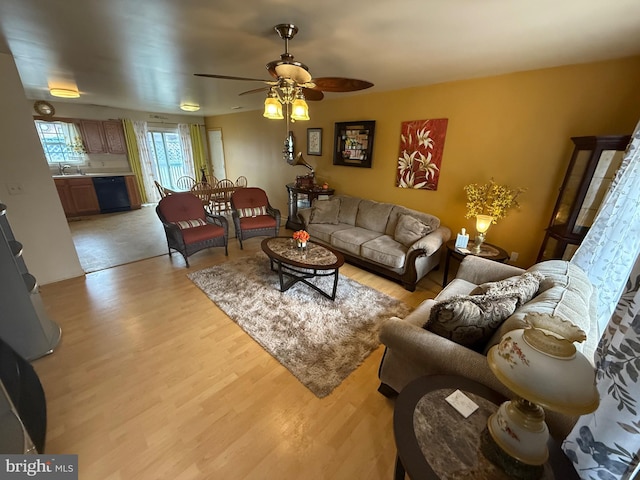 living area with light wood-style floors and ceiling fan