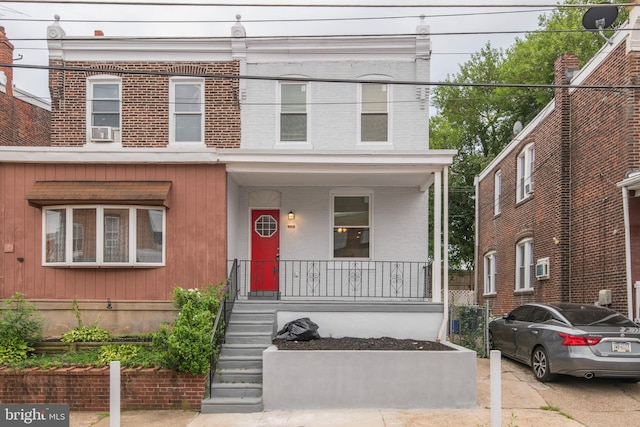 view of front of home with covered porch and brick siding