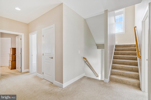 stairs featuring carpet flooring and baseboards