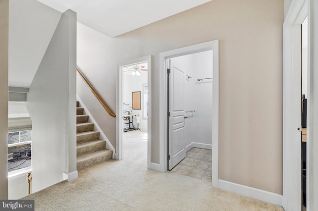 interior space with stairway and baseboards