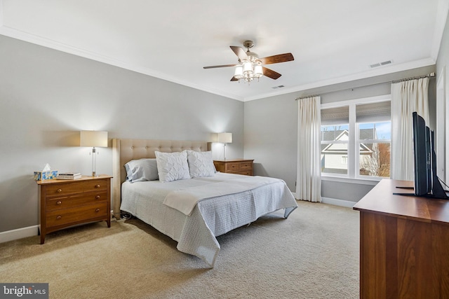 bedroom featuring baseboards, light colored carpet, visible vents, and ornamental molding