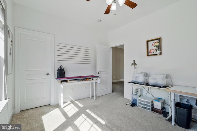 interior space featuring a ceiling fan and carpet floors