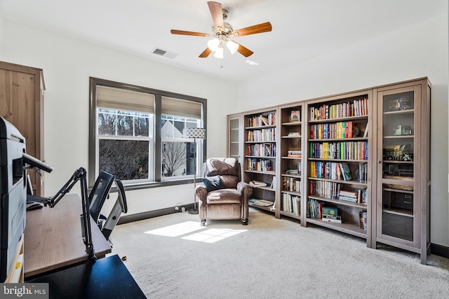 exercise room with visible vents, carpet, and ceiling fan