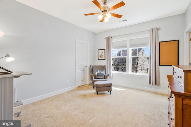 sitting room featuring visible vents, baseboards, a ceiling fan, and carpet flooring