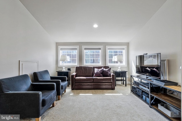 carpeted living area with a wealth of natural light and recessed lighting