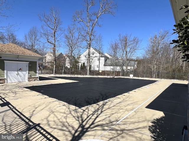 community pool featuring a patio area and fence