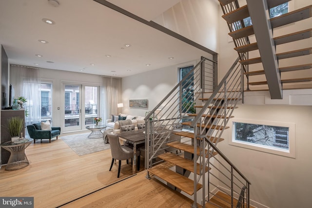 staircase featuring recessed lighting and wood finished floors