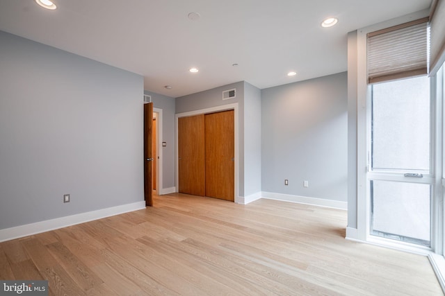 unfurnished room with baseboards, recessed lighting, visible vents, and light wood-style floors