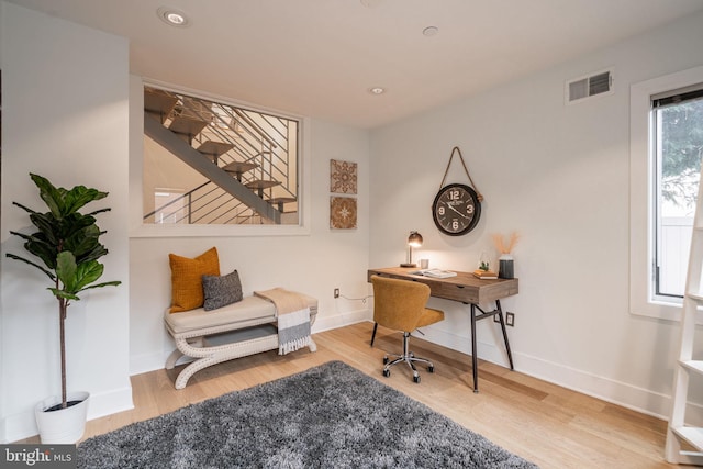 office space featuring baseboards, visible vents, wood finished floors, and recessed lighting