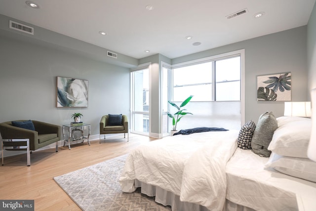 bedroom featuring light wood-type flooring, visible vents, and recessed lighting