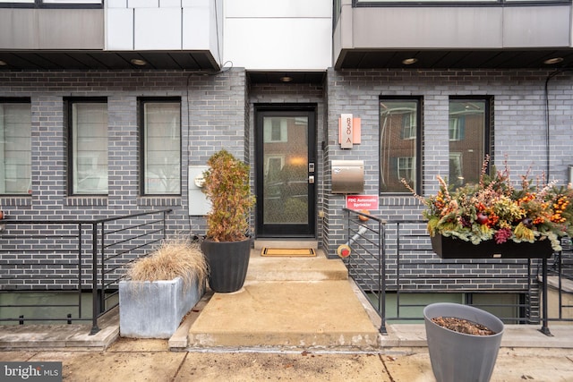 property entrance featuring brick siding