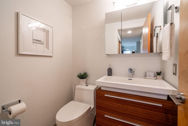 half bathroom featuring toilet and vanity