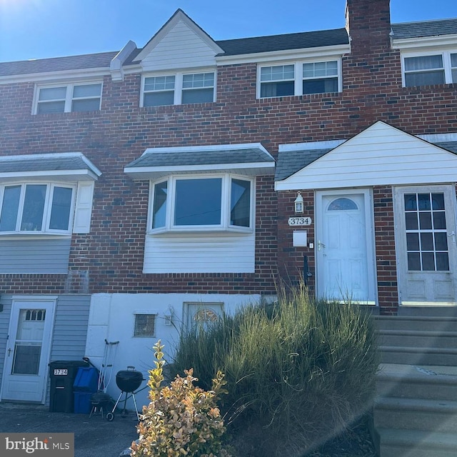 townhome / multi-family property with brick siding