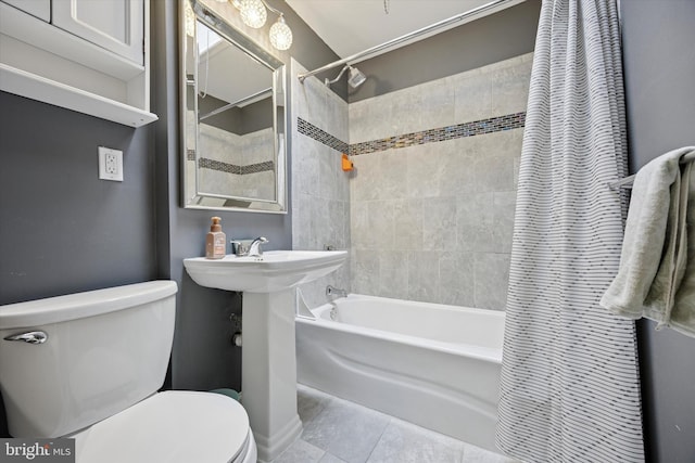 full bath with tile patterned flooring, shower / bathtub combination with curtain, and toilet