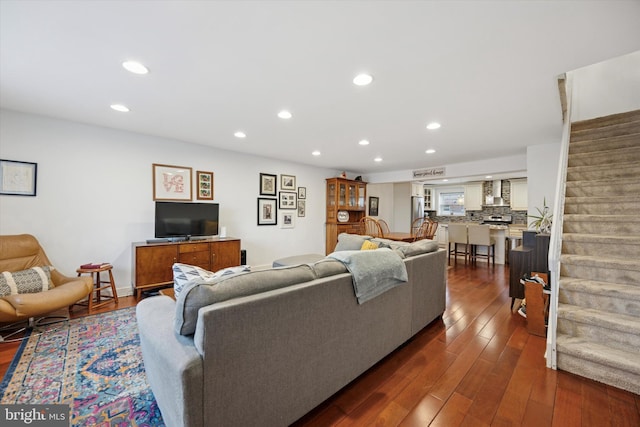 living room featuring stairs, dark wood finished floors, and recessed lighting