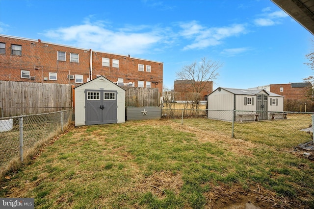 view of yard featuring a storage unit, an outdoor structure, and a fenced backyard