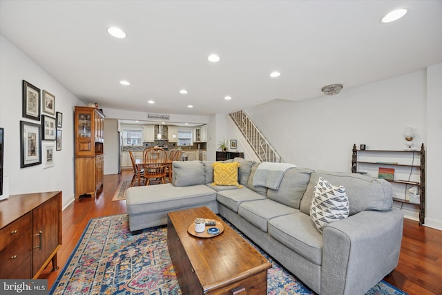 living area with stairs, dark wood-style flooring, baseboards, and recessed lighting