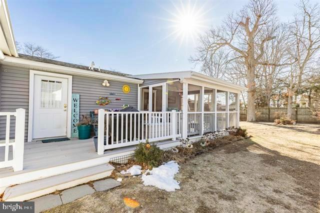 exterior space featuring fence and a sunroom