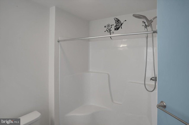 bathroom with toilet and walk in shower