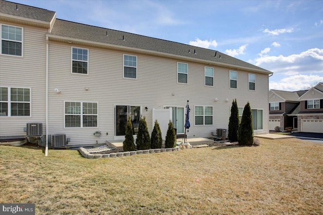 back of property featuring a yard, central AC unit, and a patio area