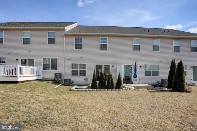 rear view of property featuring a patio area, cooling unit, a deck, and a lawn