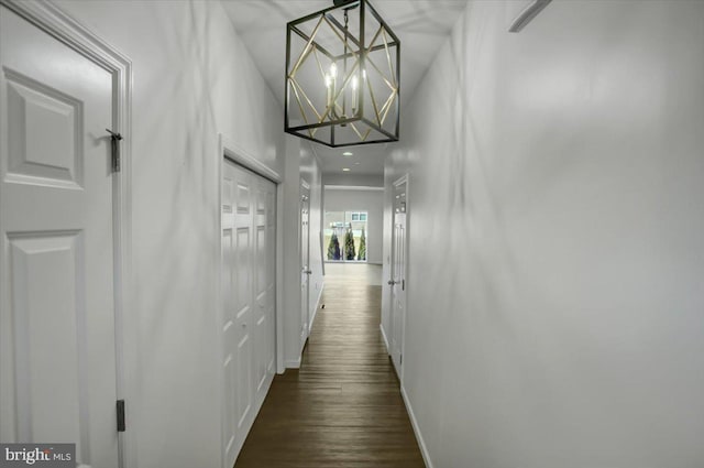 hall featuring dark wood-style floors and baseboards