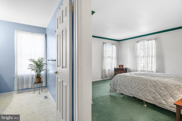 bedroom with baseboards, visible vents, and tile patterned floors