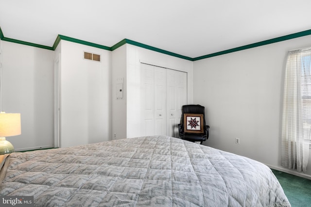 bedroom featuring ornamental molding, a closet, visible vents, and carpet flooring