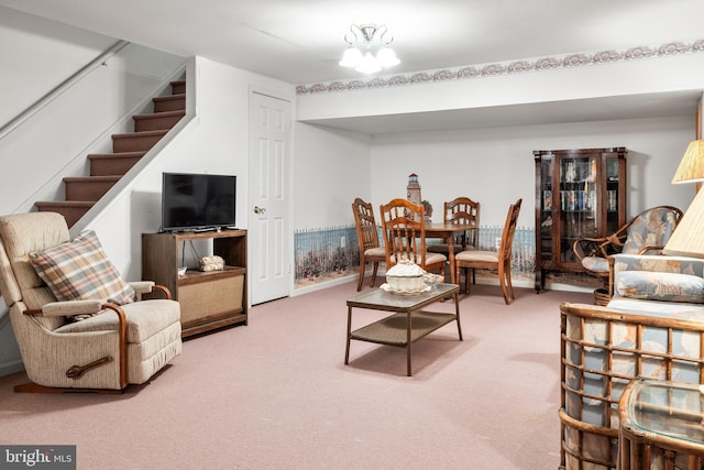 carpeted living room featuring stairs