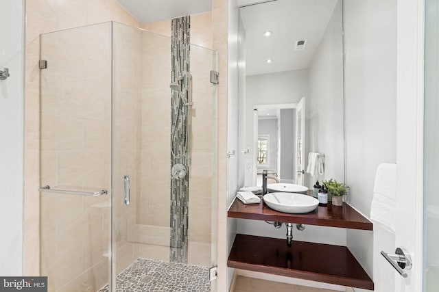 bathroom with a shower stall, visible vents, and vanity