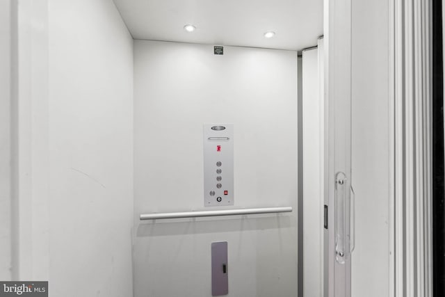 details featuring elevator and recessed lighting