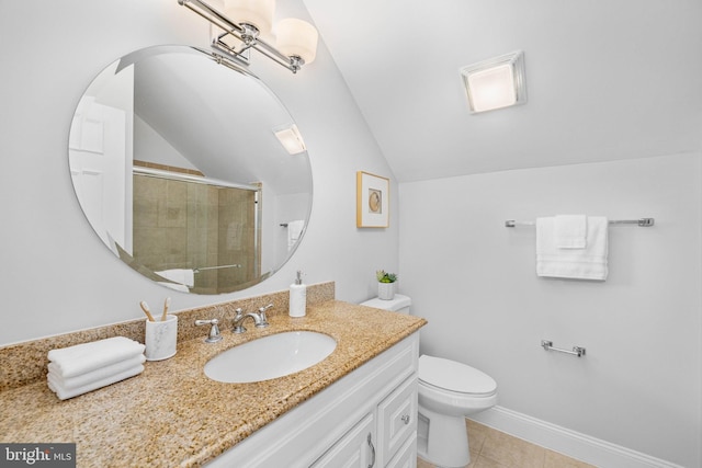 bathroom featuring baseboards, toilet, lofted ceiling, tiled shower, and vanity