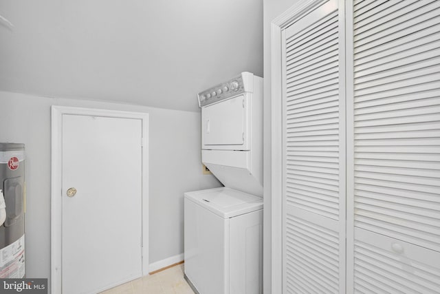 washroom with laundry area, stacked washer and clothes dryer, and water heater