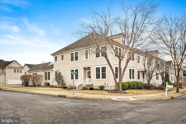 view of front of property featuring a residential view, entry steps, and central air condition unit