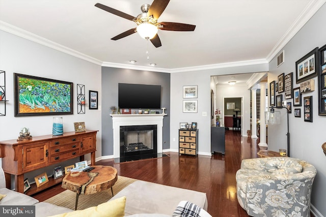 living area with wood finished floors, visible vents, baseboards, ornamental molding, and ornate columns