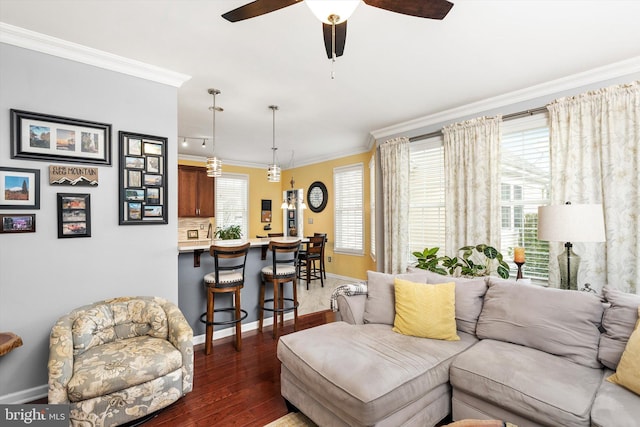 living room featuring ceiling fan, ornamental molding, wood finished floors, and baseboards