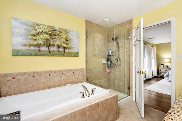 ensuite bathroom featuring visible vents, a shower stall, ensuite bath, a bath, and tile patterned floors