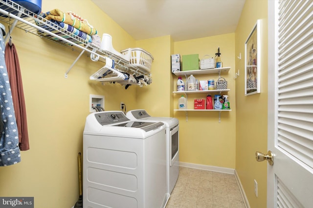 laundry room with laundry area, baseboards, light floors, and washing machine and clothes dryer